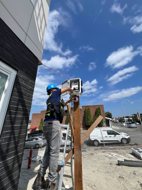 Technician servicing temporary construction security camera system